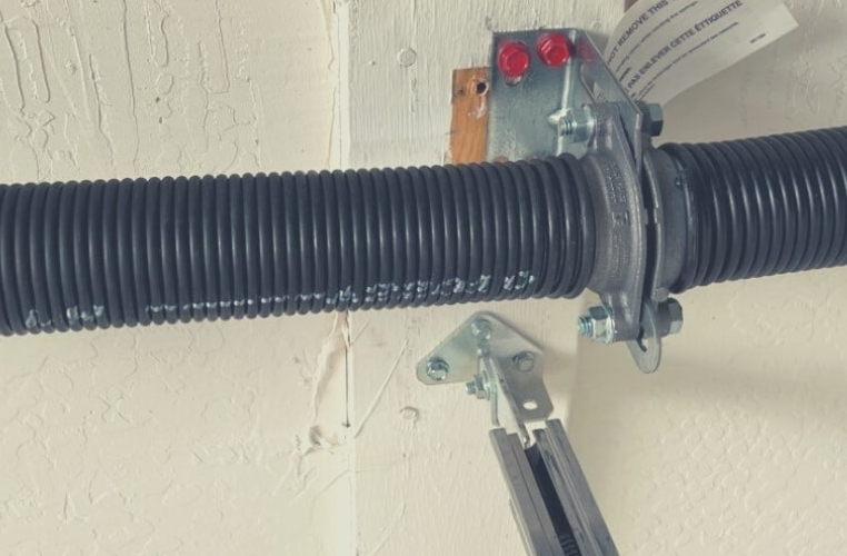 Professional technician performing garage door spring repair service in Orlando, FL for optimal door function and safety