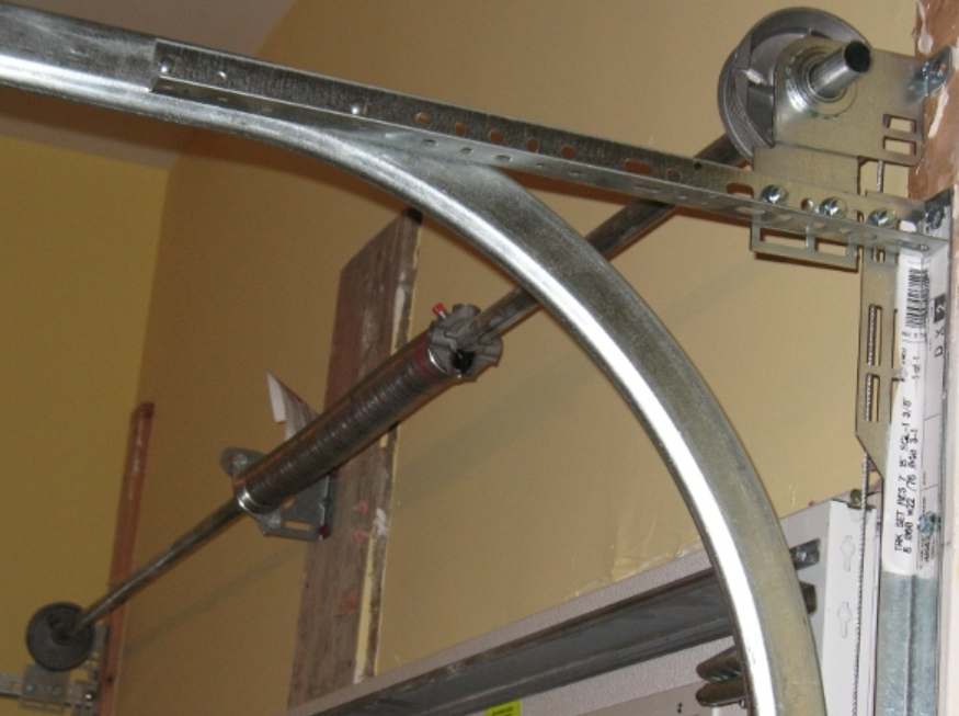 a technician inspecting and repairing a garage door track in Orlando, Florida.